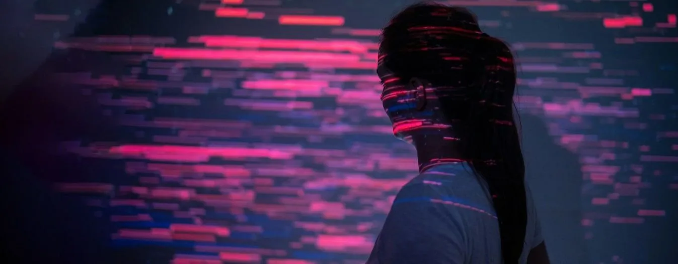 A woman looking at a screen.