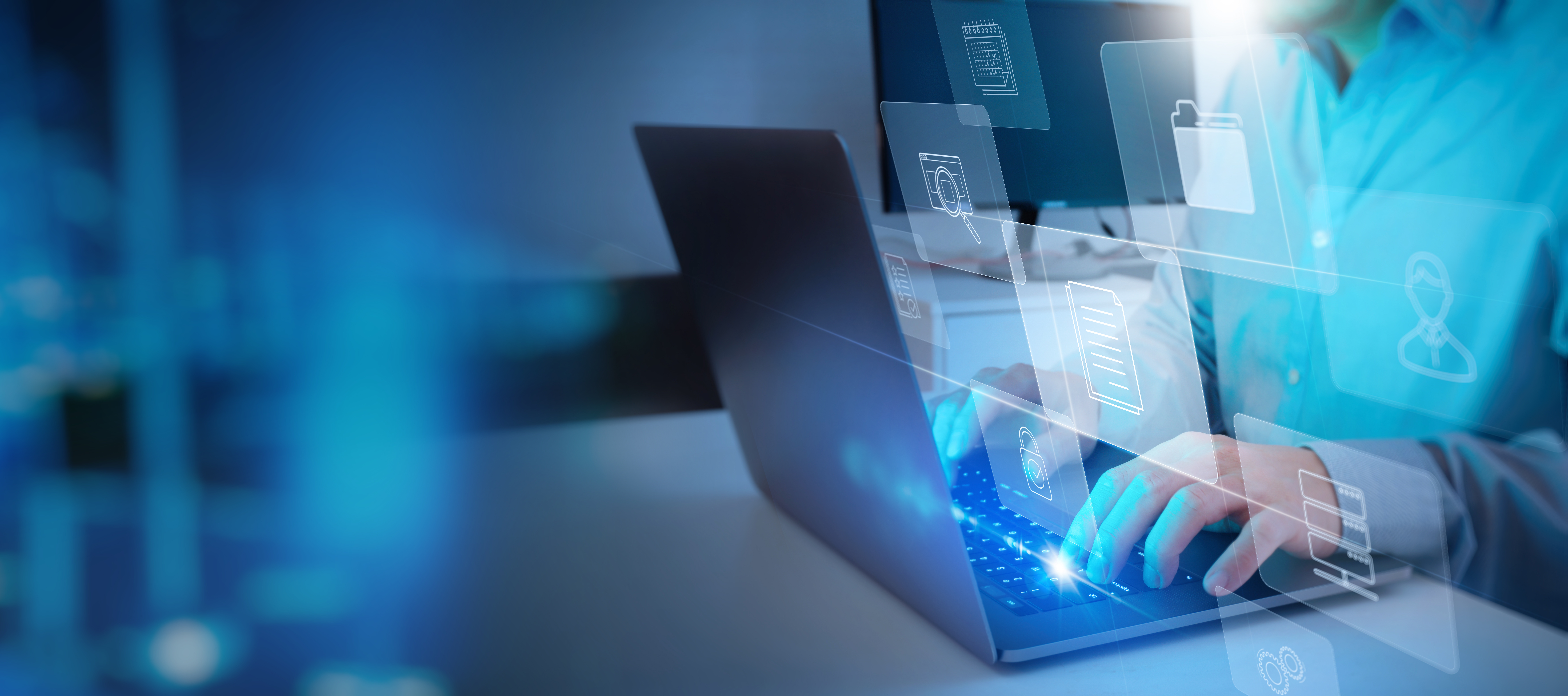 Person typing on a laptop with digital file and folder icons overlaid, representing data management or cloud computing technology.