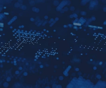 Abstract image of blue digital dots and lines forming a circuit-like pattern on a dark background, representing technology or data visualization.