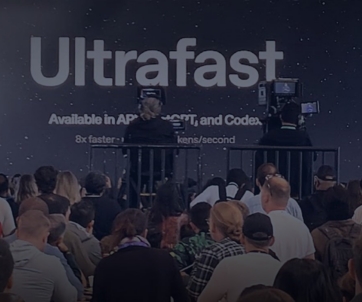 A crowd watches a presenter on stage at OpenAI Dev Day 2026, with a large screen behind displaying “Ultrafast” and technical speed details.