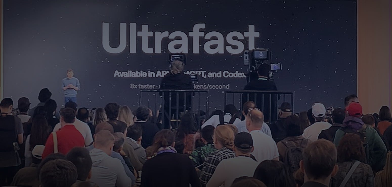 A crowd watches a presenter on stage at OpenAI Dev Day 2026, with a large screen behind displaying “Ultrafast” and technical speed details.
